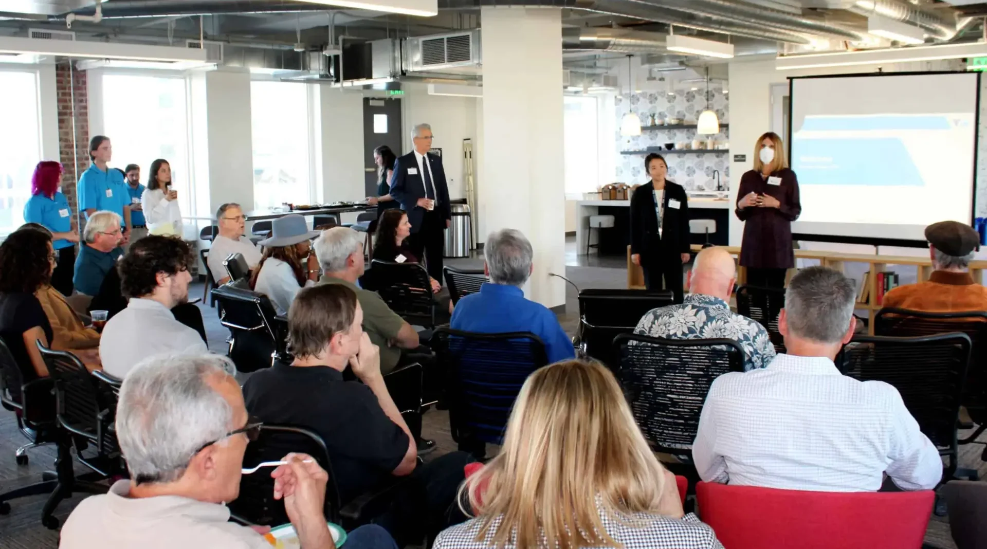 A photo of people presenting at a community engagement meeting.