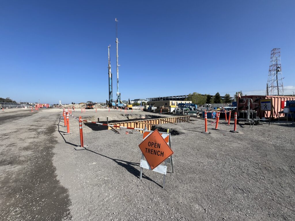 Crane mobilization to build temporary excavation support structures.