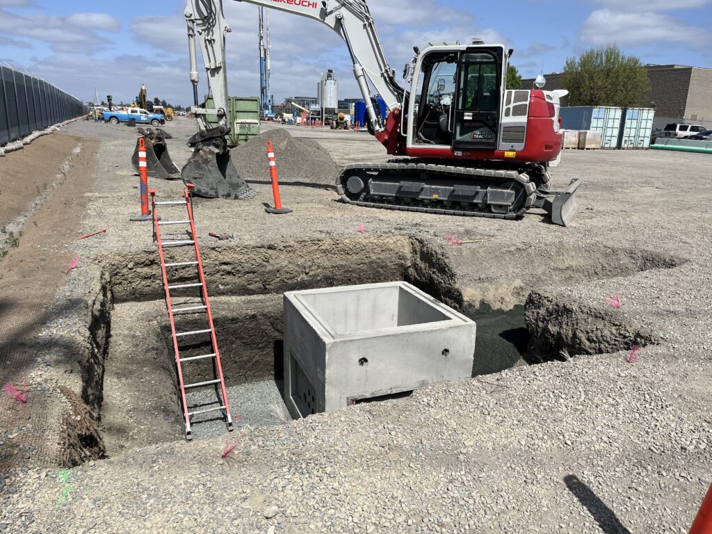 Installing temporary electrical duct-bank to support construction.