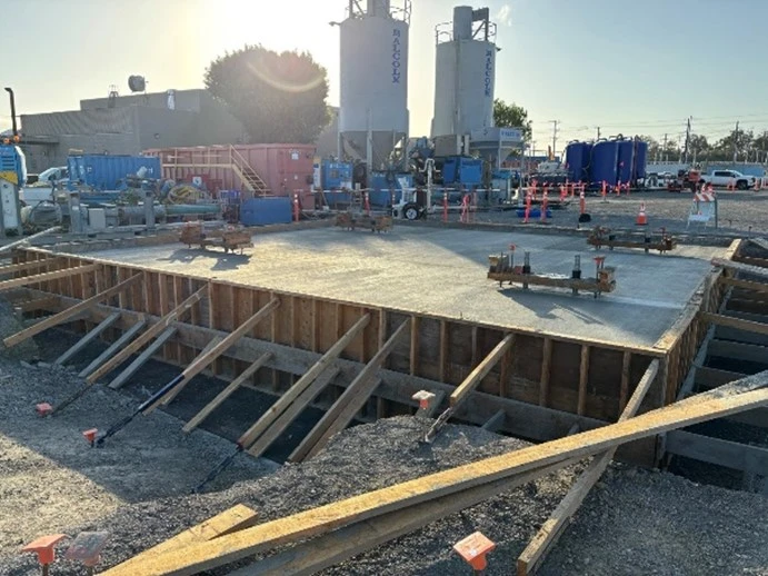 picture of Crews finishing the concrete pour for the tripping frame slab