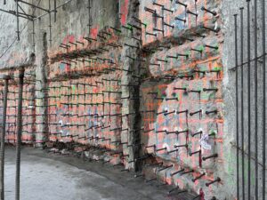 Metal dowels sticking out of tall cement walls