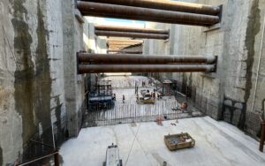View of inside caterpillar shaft. Tall cavernous cement walls with strut bearings across